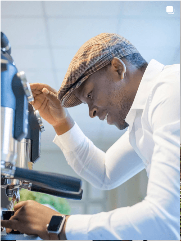 Martin Shabaya pulling an espresso shot in a white shirt